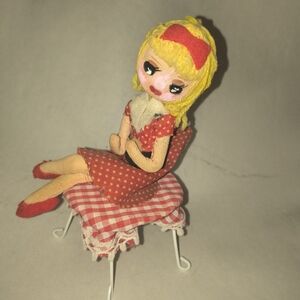 Vintage Handmade Material Doll Magnet On Table.